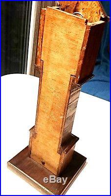 Antique Swiss pocket watch in wooden long-case holder